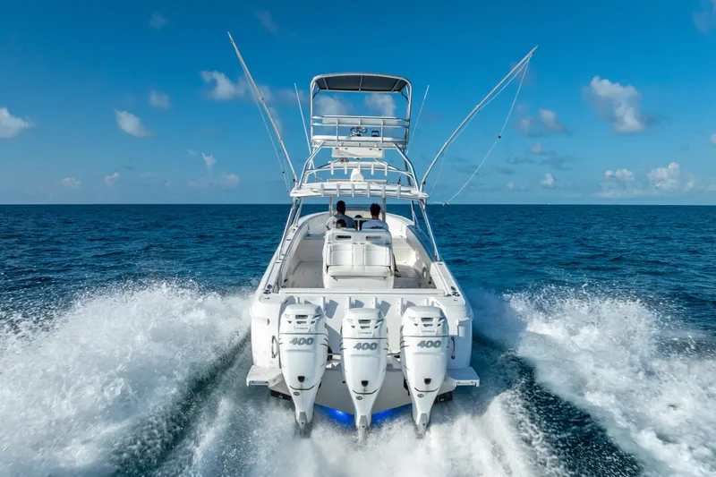  Yacht Photos Pics 2016 Intrepid 400 Center Console boat cruising on open ocean under clear blue sky.