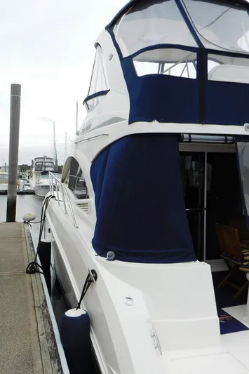  Yacht Photos Pics 2007 Sea Ray 36 Sedan Bridge yacht docked at marina with blue canopy.