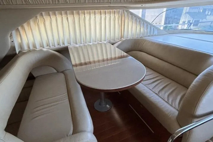 Gazoo Yacht Photos Pics Interior of 2001 Sea Ray 400 Sedan Bridge with elegant seating and table.