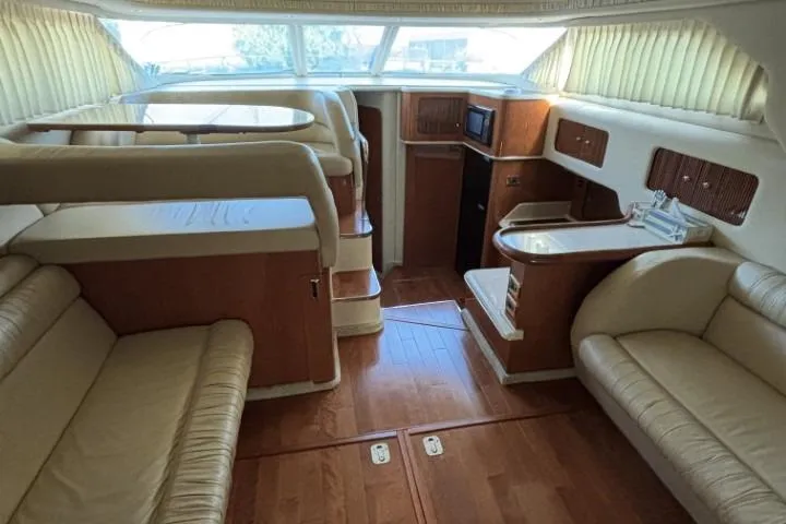Gazoo Yacht Photos Pics Interior of 2001 Sea Ray 400 Sedan Bridge yacht with luxurious seating and wood finishes.