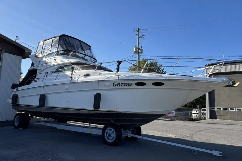 Gazoo Yacht Photos Pics 2001 Sea Ray 400 Sedan Bridge yacht on trailer, side view under clear blue sky.