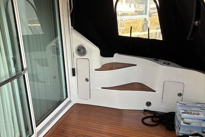 Gazoo Yacht Photos Pics 2001 Sea Ray 400 Sedan Bridge interior with wood flooring and sliding glass door.