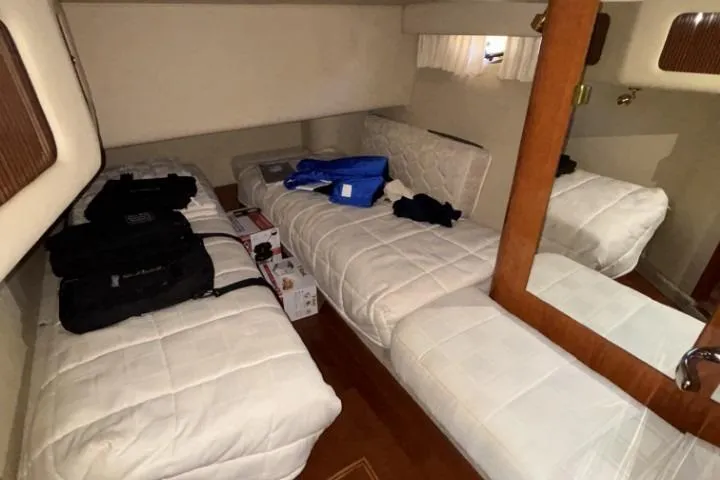 Gazoo Yacht Photos Pics Interior cabin of 2001 Sea Ray 400 Sedan Bridge with twin beds and storage items.