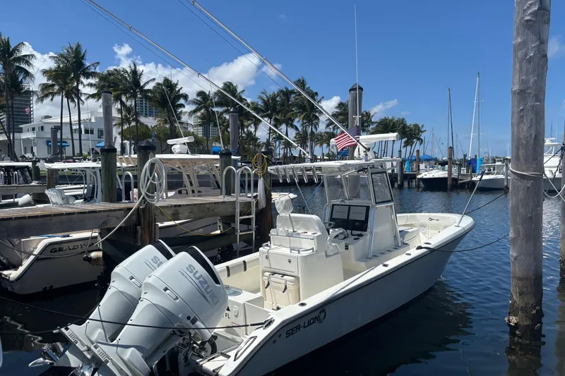  Yacht Photos Pics 2021 Sea-Lion 27 CC boat docked at marina with palm trees and clear sky.