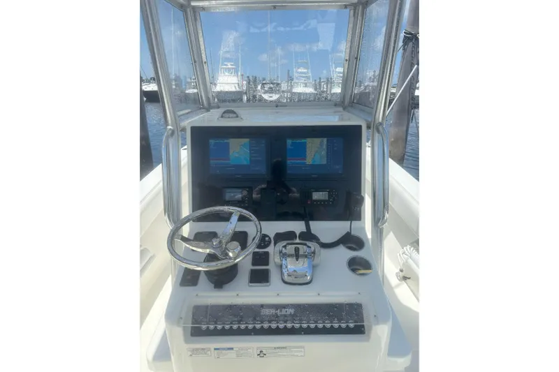  Yacht Photos Pics 2021 Sea-Lion 27 CC boat dashboard with navigation screens and steering wheel.