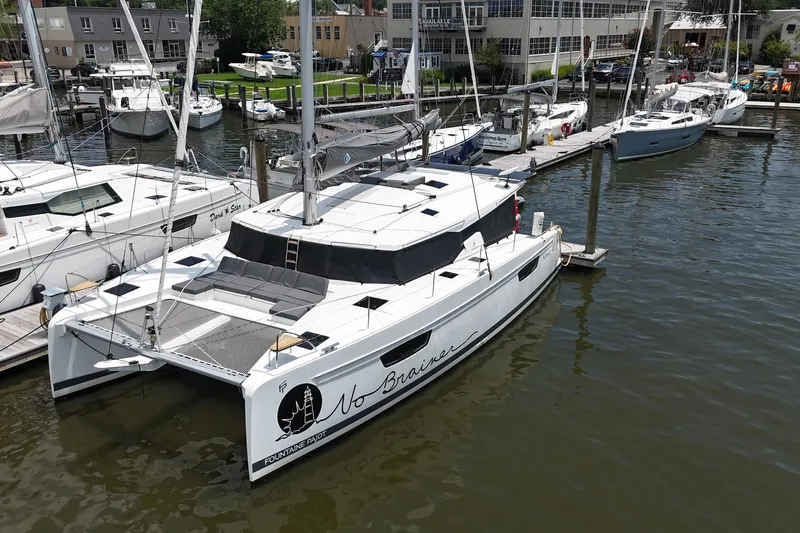 No Brainer Yacht Photos Pics 2022 Fountaine Pajot Astrea 42 catamaran docked at marina, aerial view.