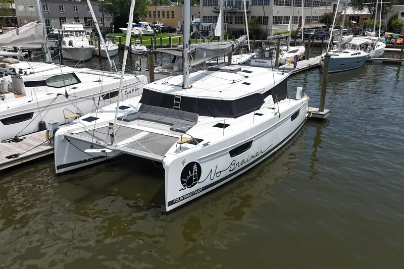 No Brainer Yacht Photos Pics 2022 Fountaine Pajot Astrea 42 catamaran docked at a marina, featuring sleek design.