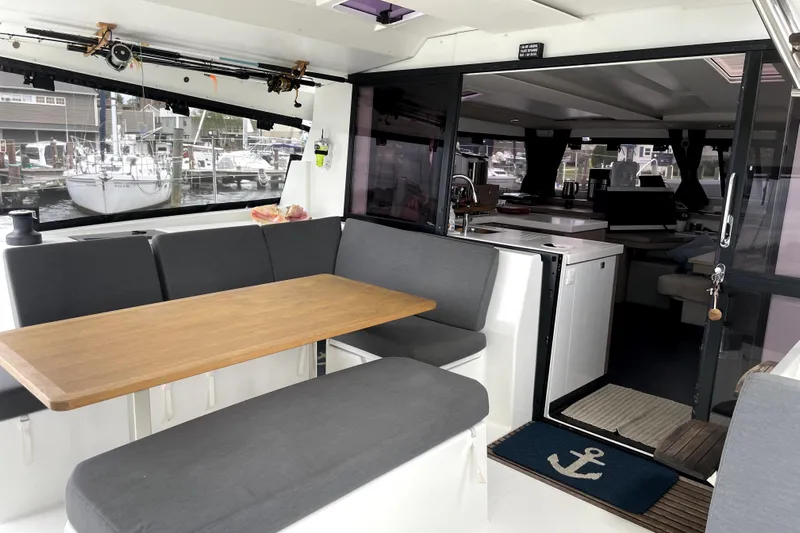 No Brainer Yacht Photos Pics Interior of 2022 Fountaine Pajot Astrea 42 catamaran with dining area and kitchen.