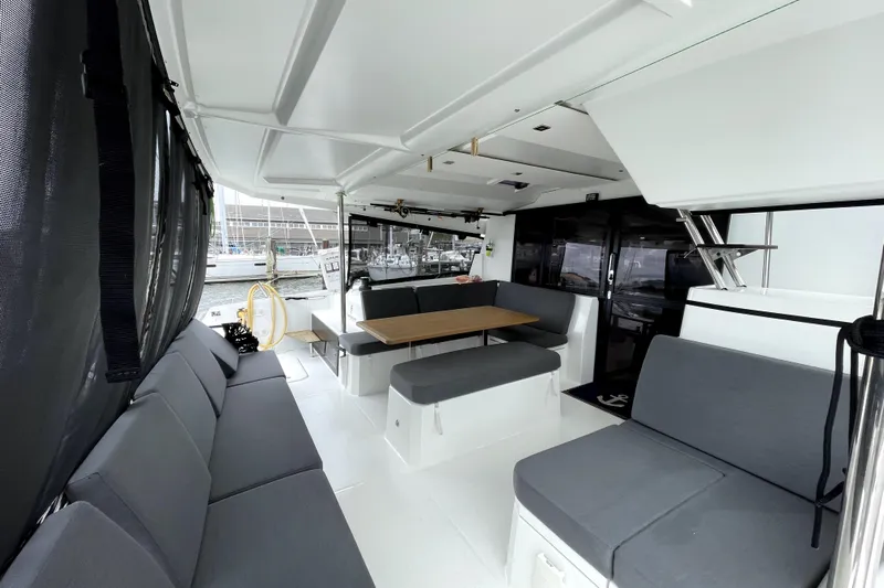 No Brainer Yacht Photos Pics Spacious interior of 2022 Fountaine Pajot Astrea 42 catamaran with modern seating and dining area.