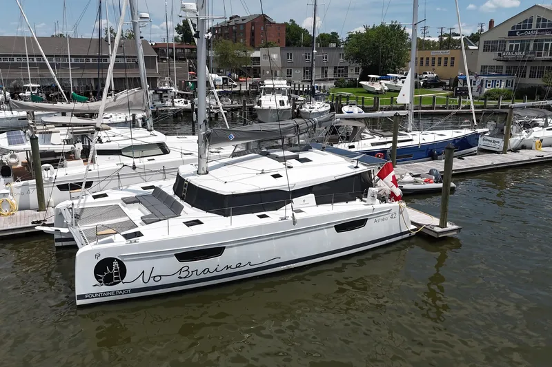 No Brainer Yacht Photos Pics 2022 Fountaine Pajot Astrea 42 catamaran docked at a marina, featuring sleek design.