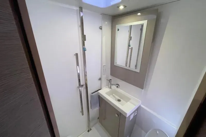 No Brainer Yacht Photos Pics Modern bathroom in 2022 Fountaine Pajot Astrea 42 yacht, featuring sleek sink and mirror.