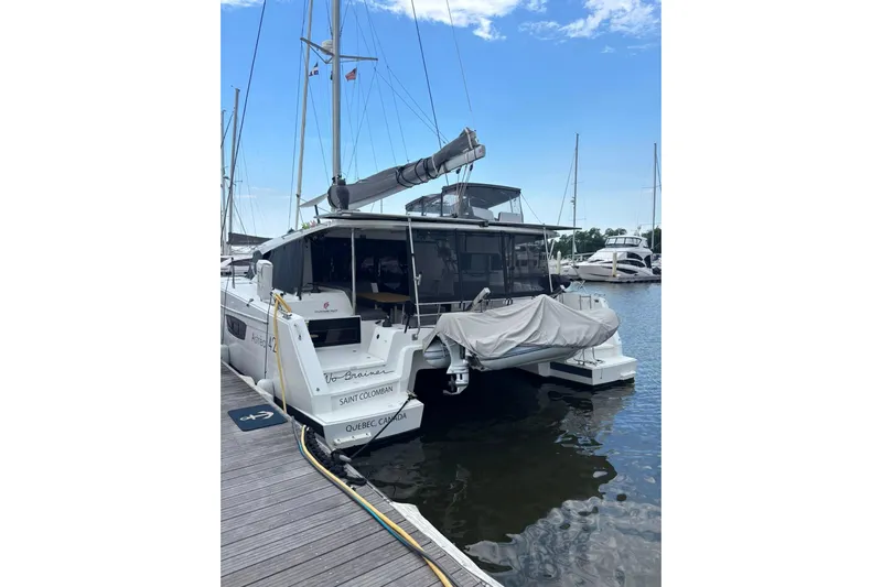 No Brainer Yacht Photos Pics 2022 Fountaine Pajot Astrea 42 catamaran docked at marina, rear view.