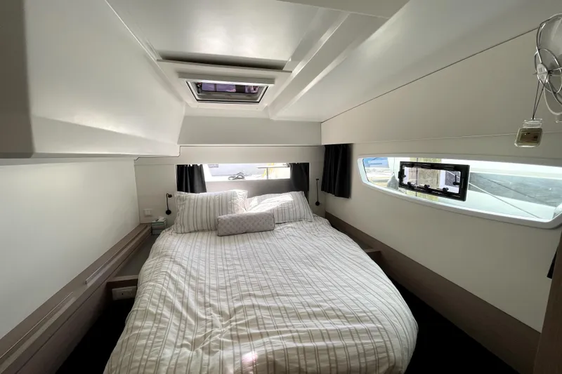 No Brainer Yacht Photos Pics Interior cabin of 2022 Fountaine Pajot Astrea 42 with cozy bed and window view.