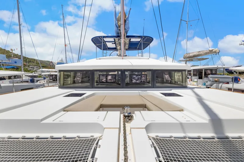 Happy Ours Yacht Photos Pics 2022 Lagoon 52 F catamaran docked, showcasing spacious deck and modern design.