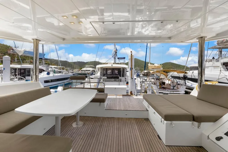Happy Ours Yacht Photos Pics Luxurious Lagoon 52 F catamaran interior, 2022 model, docked at a scenic marina.