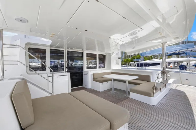 Happy Ours Yacht Photos Pics Spacious deck of 2022 Lagoon 52 F catamaran with seating and table.
