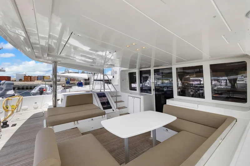 Happy Ours Yacht Photos Pics Spacious deck of 2022 Lagoon 52 F yacht with seating and table.