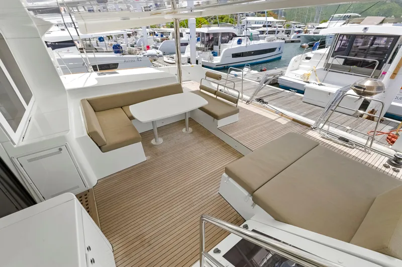 Happy Ours Yacht Photos Pics Spacious deck of 2022 Lagoon 52 F yacht with comfortable seating and table.