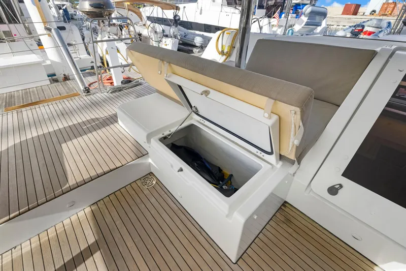 Happy Ours Yacht Photos Pics Open storage compartment on 2022 Lagoon 52 F yacht deck with wooden flooring.
