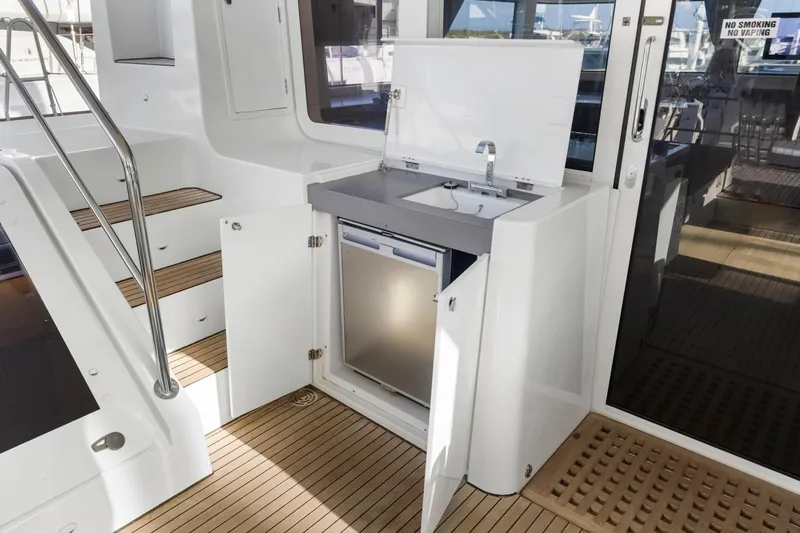 Happy Ours Yacht Photos Pics Outdoor kitchenette on 2022 Lagoon 52 F yacht with sink and storage.