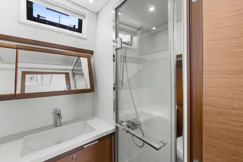 Happy Ours Yacht Photos Pics Modern bathroom interior on 2022 Lagoon 52 F yacht, featuring sleek shower and vanity.