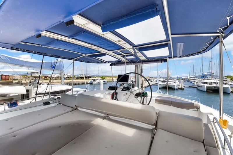 Happy Ours Yacht Photos Pics Luxurious 2022 Lagoon 52 F yacht with spacious deck and marina view.