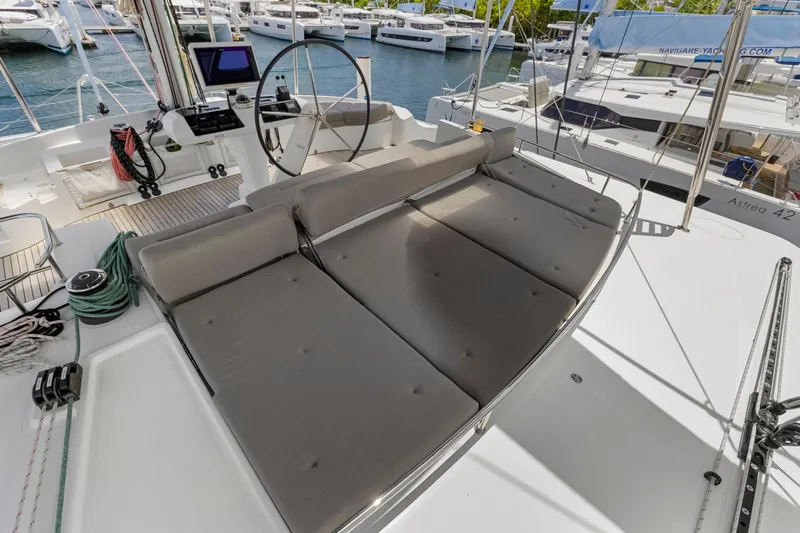 Happy Ours Yacht Photos Pics Luxurious Lagoon 52 F catamaran deck with helm, seating, and marina view, 2022 model.