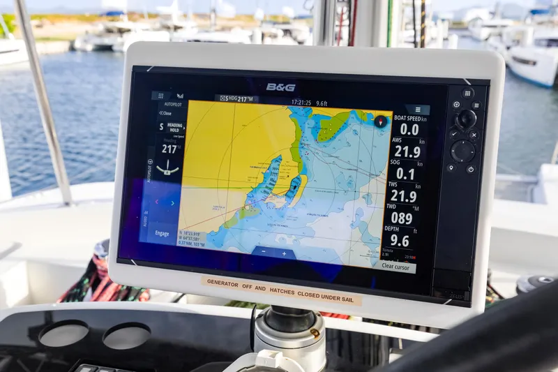 Happy Ours Yacht Photos Pics Navigation display on a 2022 Lagoon 52 F catamaran, showing nautical charts and sailing data.