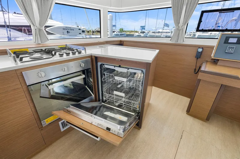 Happy Ours Yacht Photos Pics Modern kitchen in 2022 Lagoon 52 F yacht with stove, oven, and dishwasher.