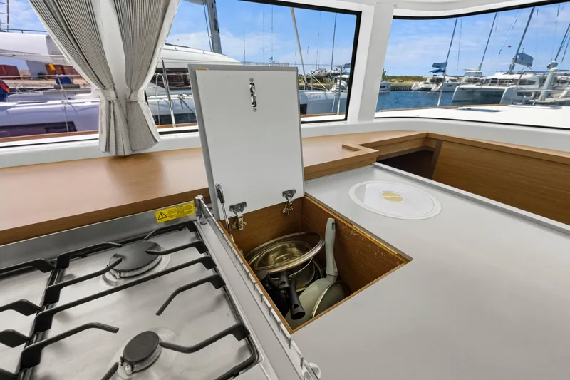Happy Ours Yacht Photos Pics Modern kitchen on 2022 Lagoon 52 F yacht with stove and storage.