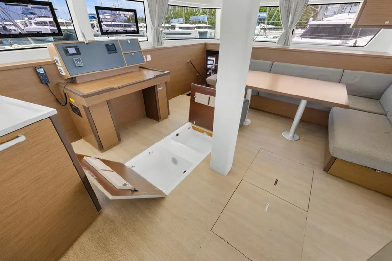 Happy Ours Yacht Photos Pics Interior of 2022 Lagoon 52 F yacht with open storage compartment and modern seating area.