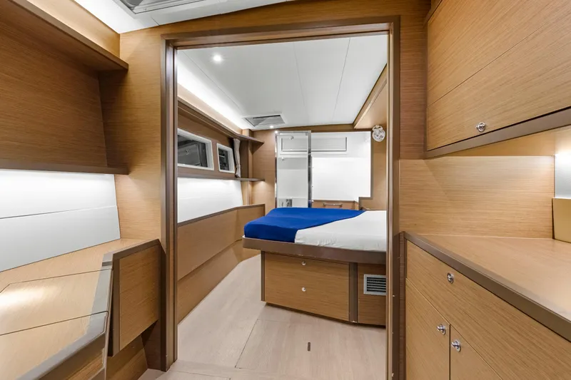 Happy Ours Yacht Photos Pics Luxurious interior of 2022 Lagoon 52 F yacht cabin with modern wood finish.