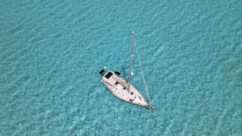 Via Yacht Photos Pics Sailboat Caliber 40 LRC SE 2004 on clear turquoise water, aerial view.