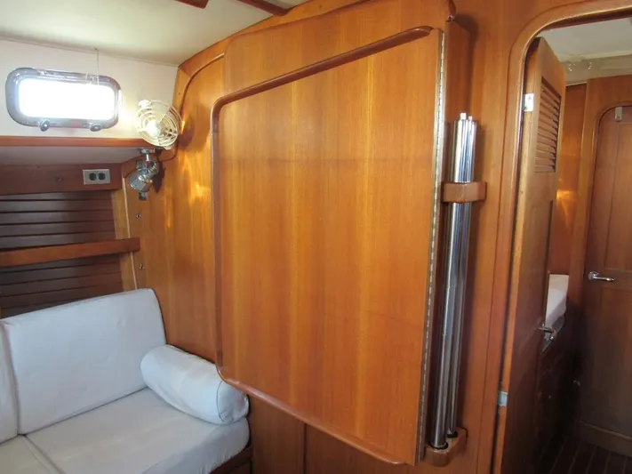 Via Yacht Photos Pics Interior of 2004 Caliber 40 LRC SE yacht with wooden paneling and white seating.