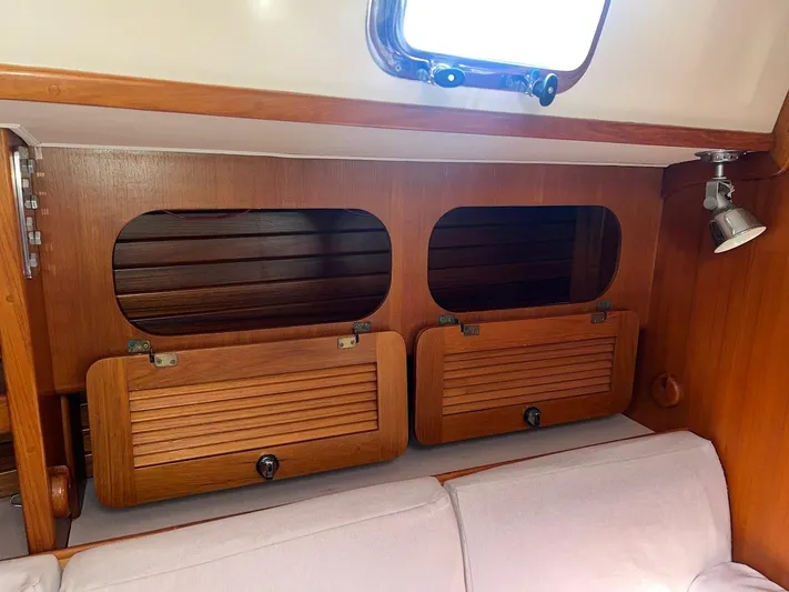 Via Yacht Photos Pics Interior of 2004 Caliber 40 LRC SE sailboat with wooden cabinets and seating.