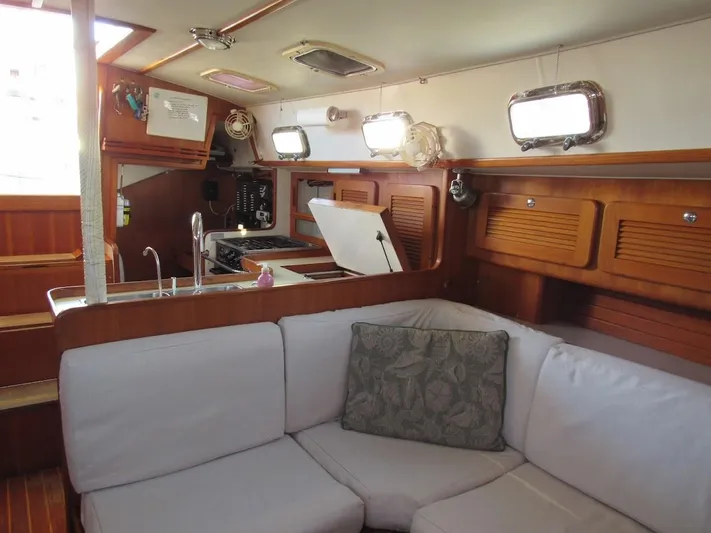 Via Yacht Photos Pics Interior of 2004 Caliber 40 LRC SE yacht with cozy seating and wooden cabinetry.