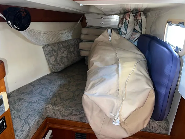 Via Yacht Photos Pics Cozy cabin interior of 2004 Caliber 40 LRC SE sailboat with cushions and storage.