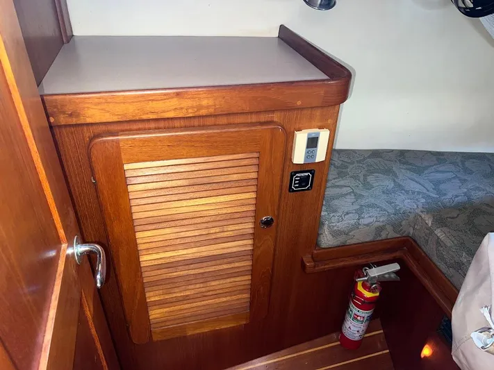 Via Yacht Photos Pics Wooden interior of 2004 Caliber 40 LRC SE yacht with fire extinguisher and control panel.