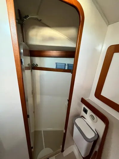 Via Yacht Photos Pics Shower area in 2004 Caliber 40 LRC SE yacht, featuring wood trim and compact design.