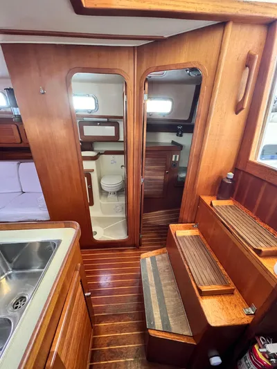 Via Yacht Photos Pics Interior of 2004 Caliber 40 LRC SE yacht, featuring wooden cabinetry and compact bathroom.