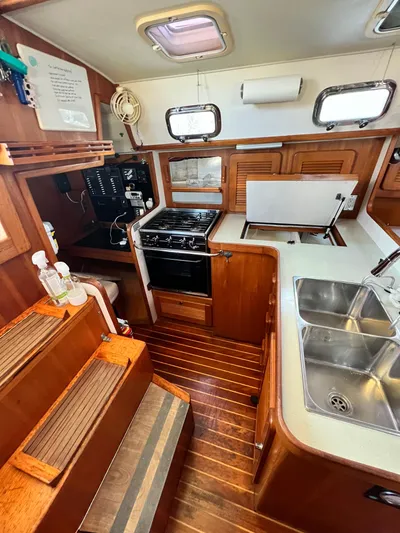 Via Yacht Photos Pics 2004 Caliber 40 LRC SE yacht interior with kitchen, stove, and dual sinks.