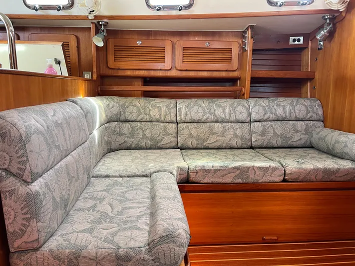 Via Yacht Photos Pics Interior of 2004 Caliber 40 LRC SE yacht with cushioned seating and wooden cabinetry.
