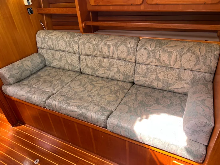 Via Yacht Photos Pics Floral-patterned sofa in 2004 Caliber 40 LRC SE yacht interior, with wooden paneling.