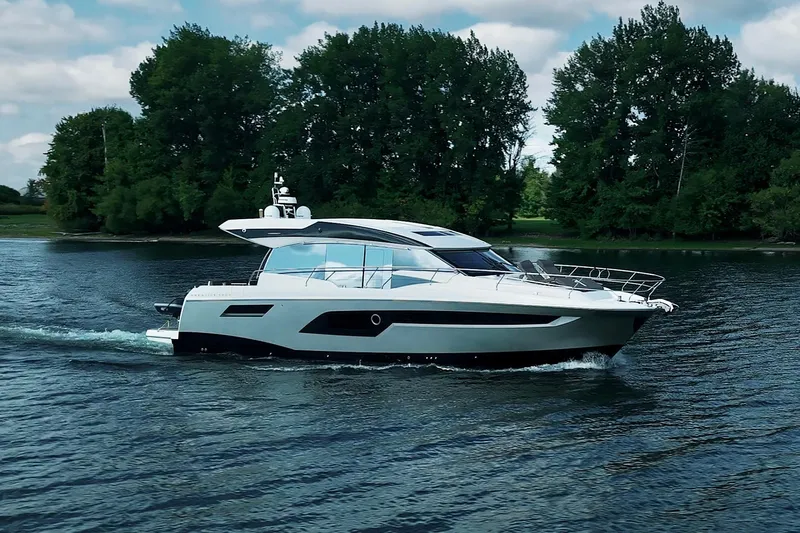 Prestige 520s Yacht Photos Pics 2018 Prestige 520S yacht cruising on a serene lake with lush green trees.