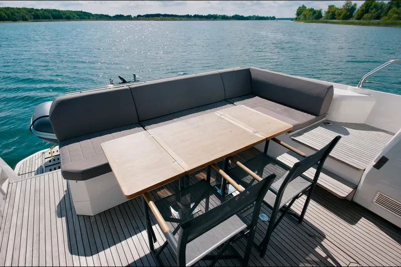 Prestige 520s Yacht Photos Pics Luxury 2018 Prestige 520S yacht deck with seating and table, overlooking serene water.