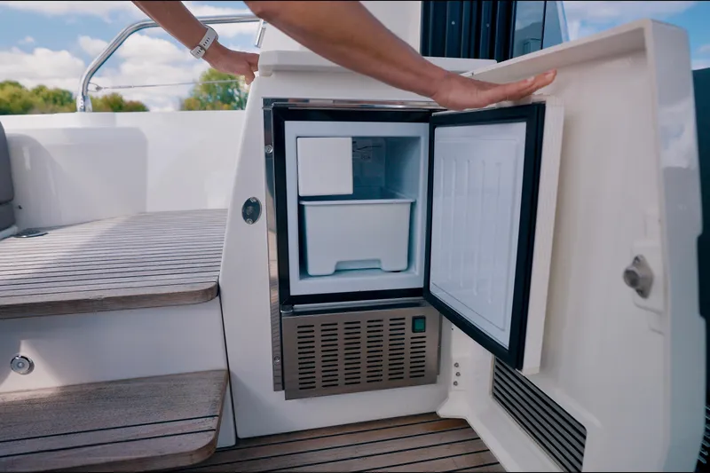 Prestige 520s Yacht Photos Pics Open mini fridge on 2018 Prestige 520S yacht, showcasing interior storage space.