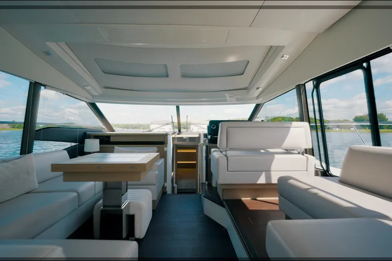 Prestige 520s Yacht Photos Pics Luxurious interior of a 2018 Prestige 520S yacht with modern seating and panoramic windows.