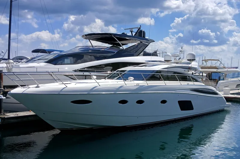  Yacht Photos Pics Luxury 2015 Princess V62-S yacht docked at marina under blue sky.