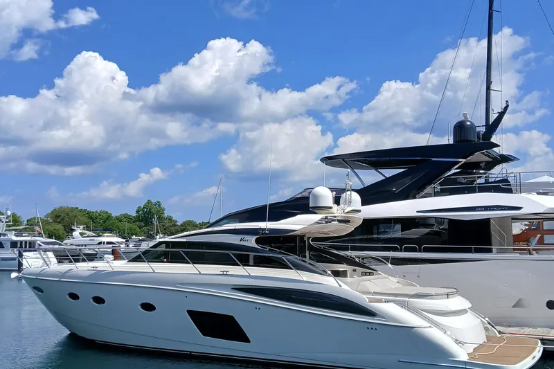  Yacht Photos Pics 2015 Princess V62-S yacht docked under a bright blue sky with clouds.