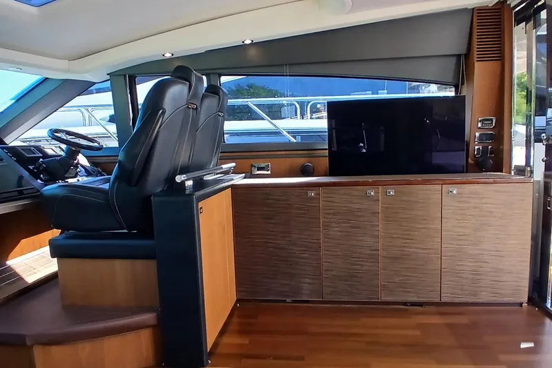  Yacht Photos Pics Luxurious interior of 2015 Princess V62-S yacht with leather seats and modern cabinetry.